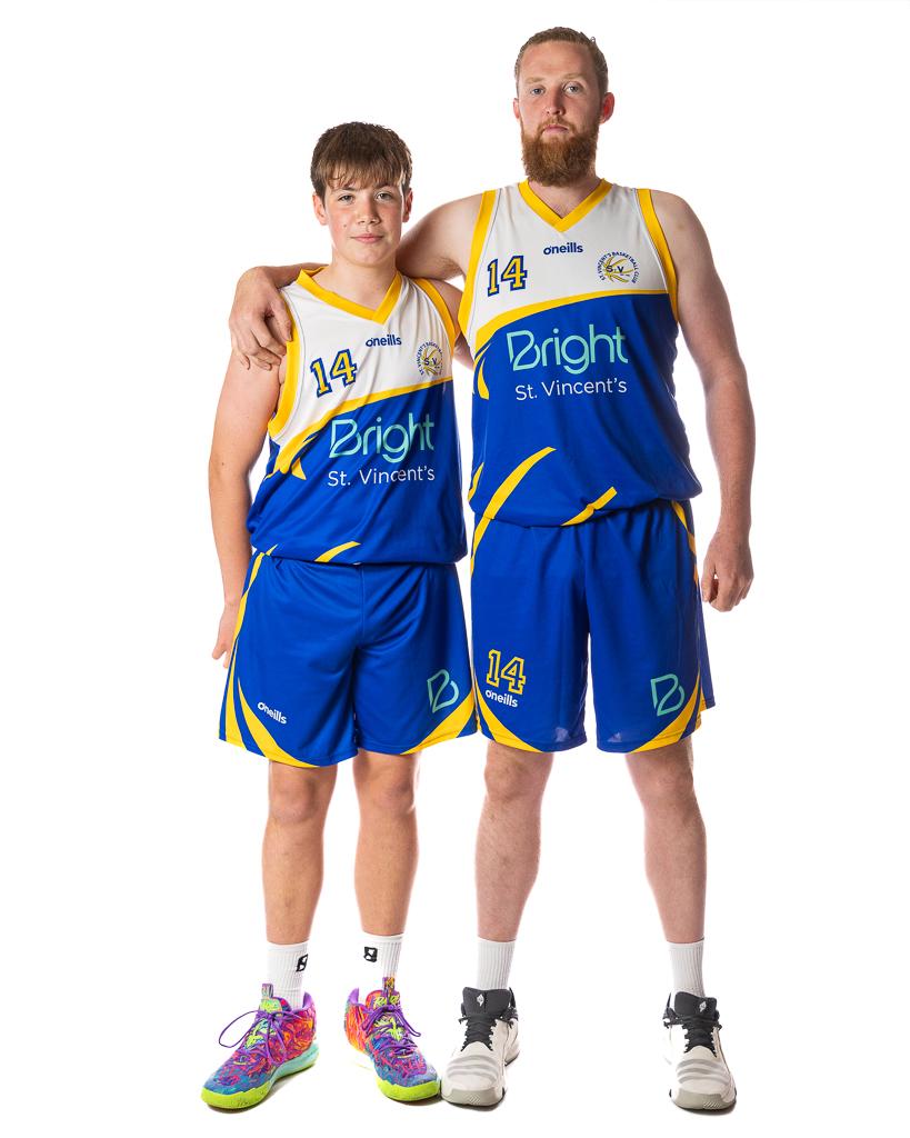A young Vincent's player and a senior player, both in Bright St. Vincent's jerseys